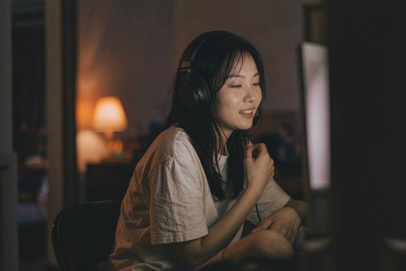 戴着耳机在语音直播间里边听边说的用户